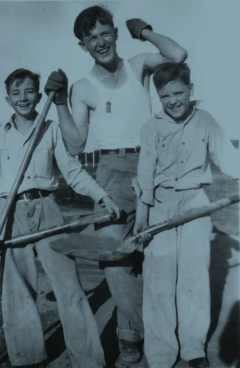 Boys with shovels on farm